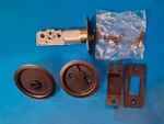 Kwikset 335 11P Rnd Pckt Dr Lck, Round Pocket Door Lock, Venetian Bronze. Fixed Price $21.35.